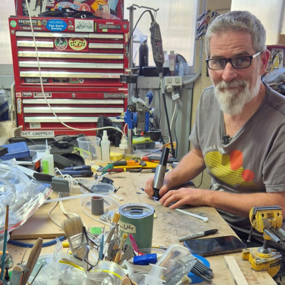 Tim McGaw at workshop desk